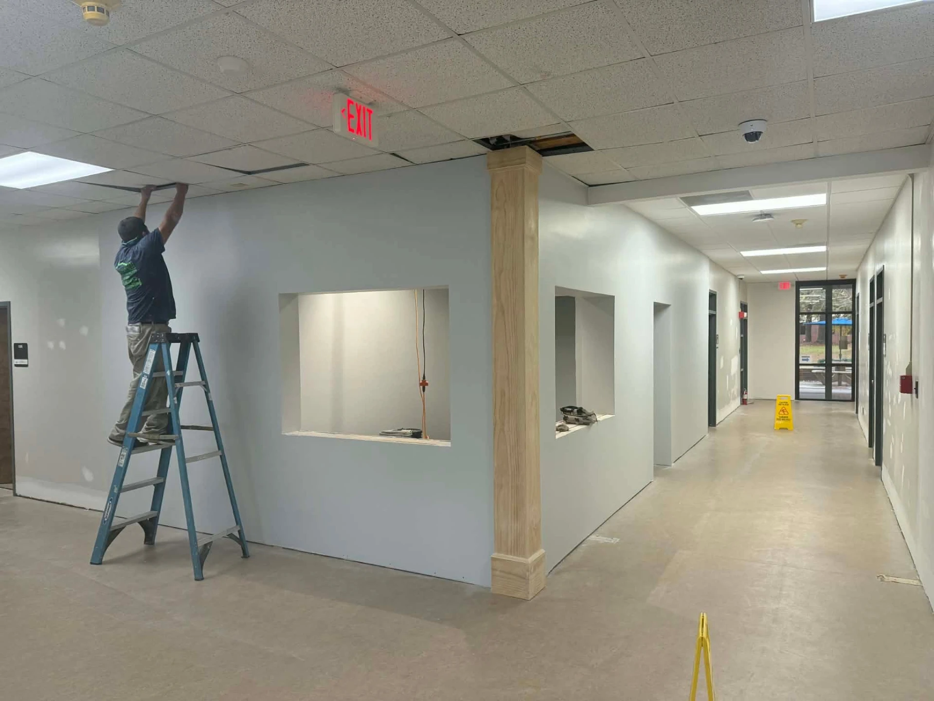 Commercial interior renovation with new walls, openings, and column trim