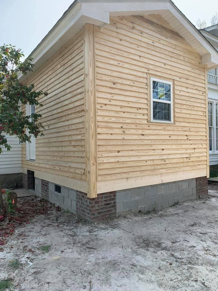 Room addition finished with new wood lap siding over a brick and block foundation