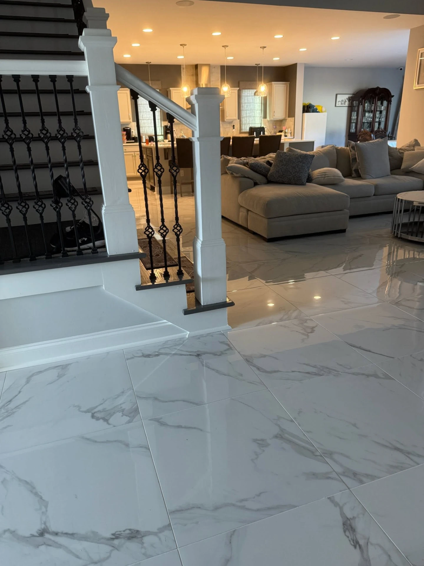 Open-plan home remodel with tiled floors, finished staircase, and updated kitchen
