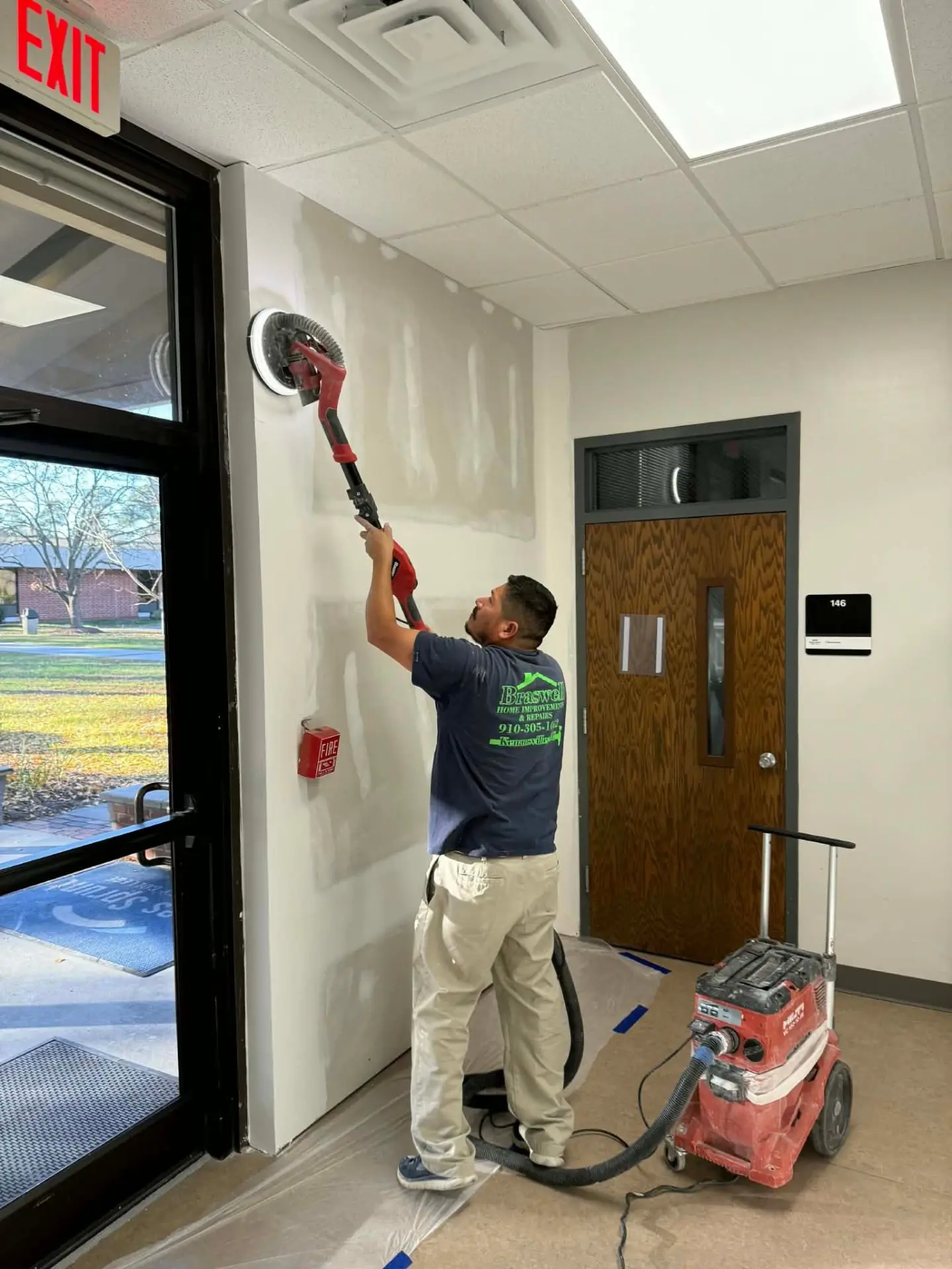 Braswell crew member finishing drywall in a commercial building