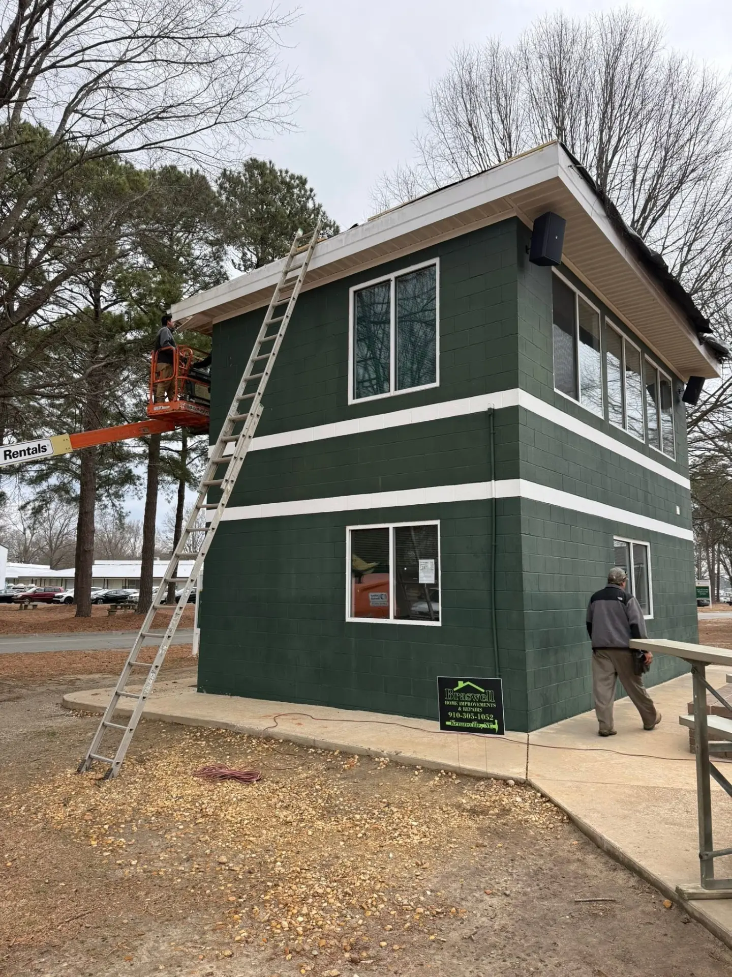 Commercial exterior renovation with fresh green and white finish work
